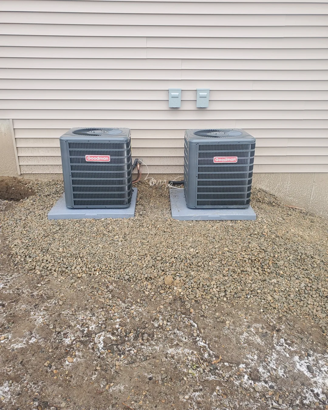 Pair of heat pump condensers installed on pads by AirPrime