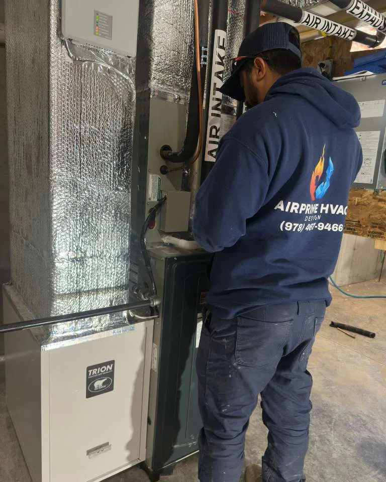AirPrime technician diagnosing an installed air handler on site