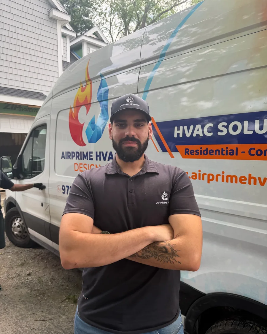 Gustavo Miranda, Owner of AirPrime HVAC Design, in front of a branded service van